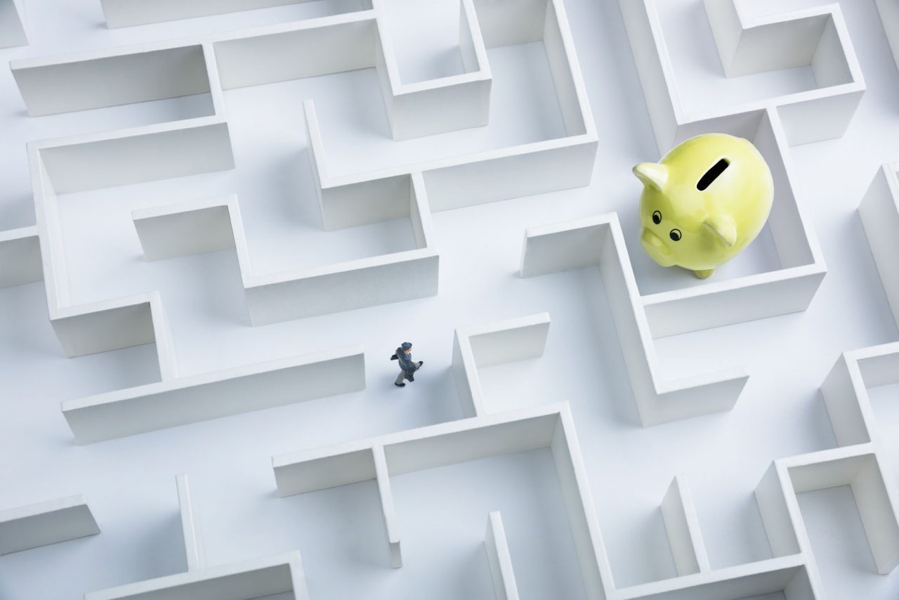 Businessman,Searching,For,Piggy,Bank,Hidden,Inside,A,Maze