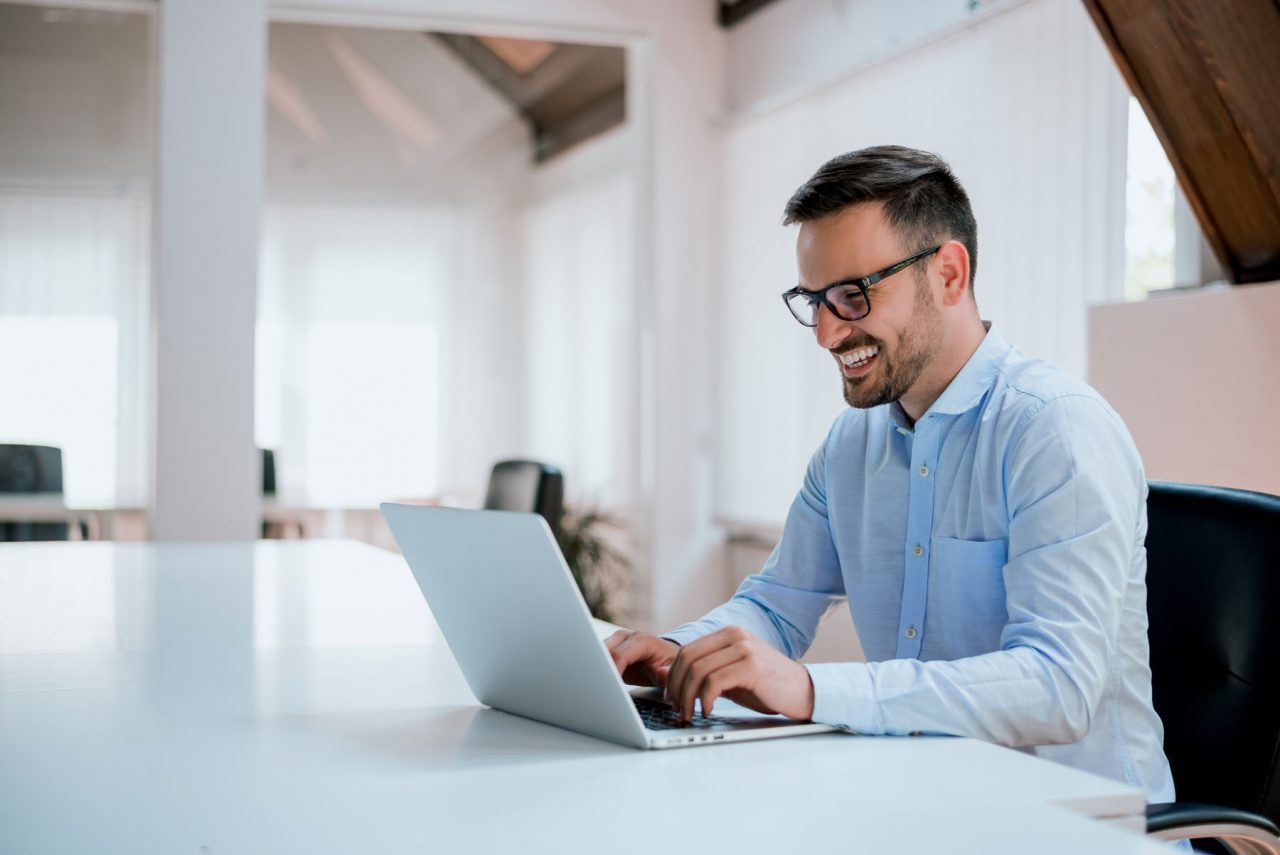 Portrait,Of,Young,Man,Sitting,At,His,Desk,In,The